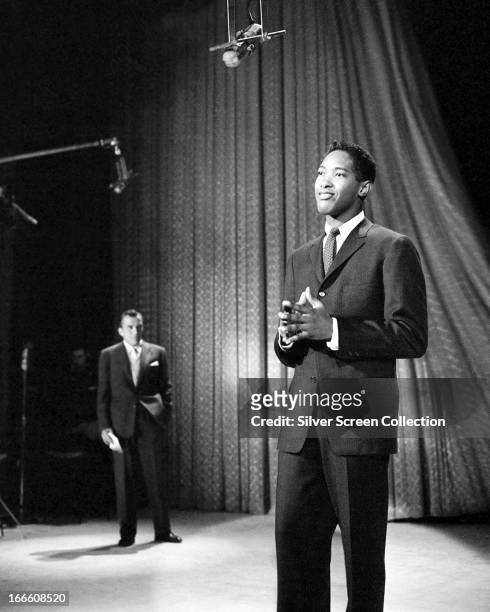 Host Ed Sullivan watches singer Sam Cooke performing on The Ed Sullivan Show, New York City, 1957.