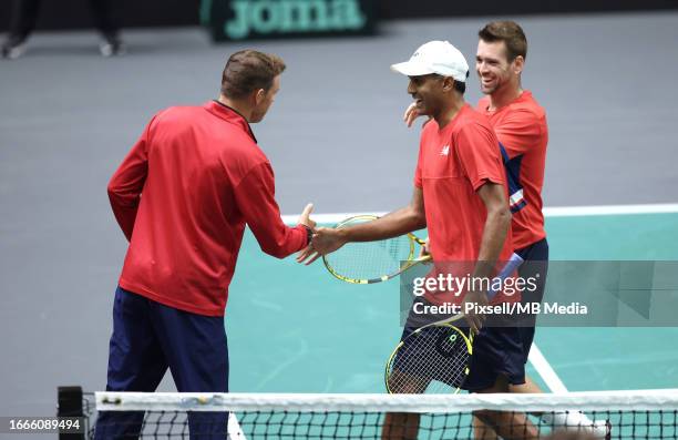 Austin Krajicek and Rajeev Ram of USA shake hands with Team Captain of USA Bob Bryan during the 2023 Davis Cup Finals Group D Stage match between...