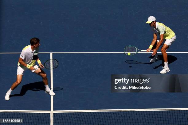 Pierre-Hugues Herbert and Nicolas Mahut of France return a shot against Rohan Bopanna of India and Matthew Ebden of Australia during their Men's...