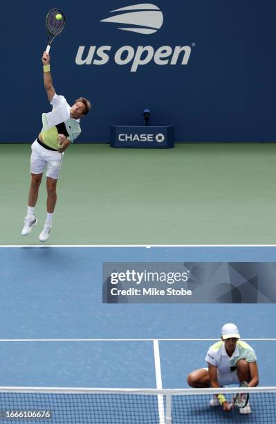 Pierre-Hugues Herbert and Nicolas Mahut of France serve against Rohan Bopanna of India and Matthew Ebden of Australia during their Men's Doubles...