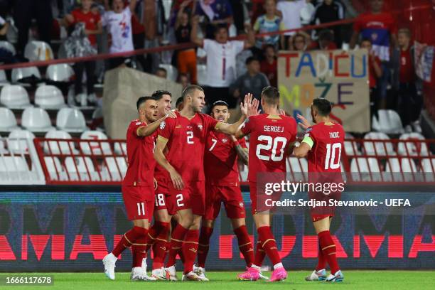 Players of Serbia celebrate after Attila Szalai of Hungary scored an own goal to make it the first goal for Serbia during the UEFA EURO 2024 European...