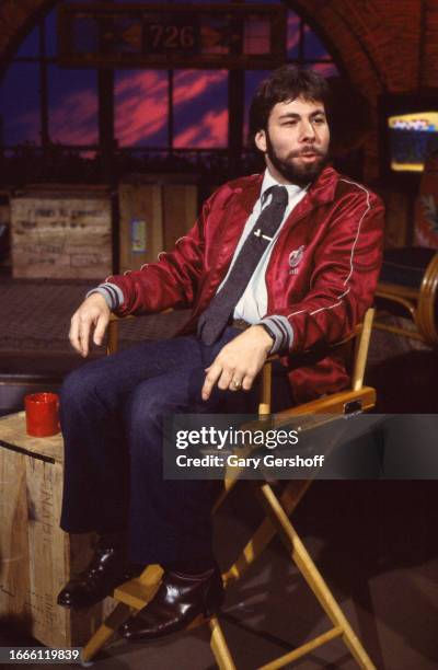 View of American computer engineer and programmer Steve Wozniak, co-founder of Apple Computer, as he sits in a director's chair during an interview...