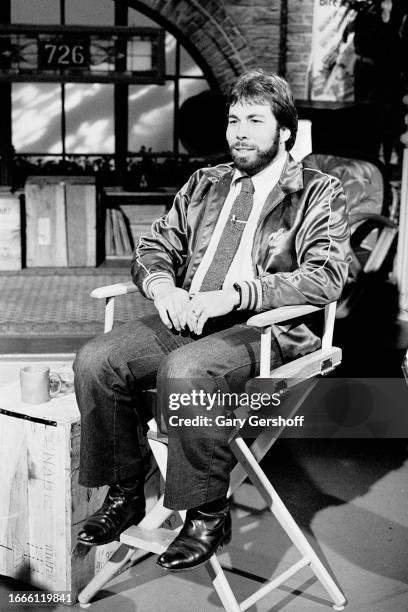 View of American computer engineer and programmer Steve Wozniak, co-founder of Apple Computer, as he sits in a director's chair during an interview...