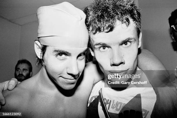 Close-up of American Rock musicians Anthony Kiedis and Flea , both of the American group Red Hot Chili Peppers, pose backstage following their...