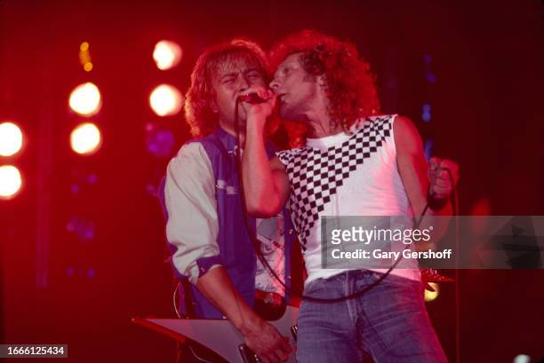Rock musicians Mick Jones, on electric guitar, and singer Lou Gramm , both of the group Foreigner, perform onstage at Byrne Arena, East Rutherford,...