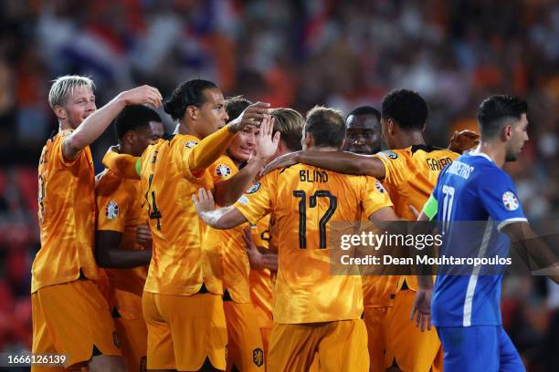 Marten de Roon of Netherlands celebrates with teammates after scoring the team's first goal during the UEFA EURO 2024 European qualifier match...