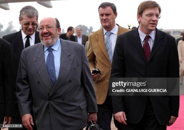 Belgian Prime Minister Guy Verhofstadt and Foreign Affairs Minister Louis Michel arrive 06 April 2004 at Kigali international Airport to attend the...