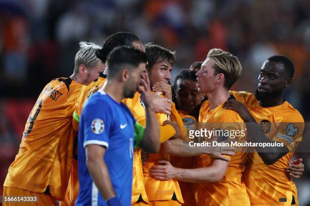 Marten de Roon of Netherlands celebrates with teammates after scoring the team's first goal during the UEFA EURO 2024 European qualifier match...