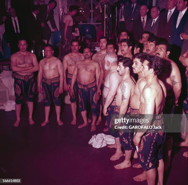 Iran. En Iran, dans une 'Zurkhaneh', c'est-à-dire un gymnase traditionnel, un groupe d'hommes torses nus, portant des pantalons courts brodés style...