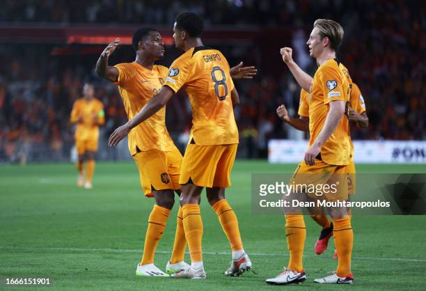 Cody Gakpo of Netherlands celebrates with teammate Denzel Dumfries after scoring the team's second goal during the UEFA EURO 2024 European qualifier...