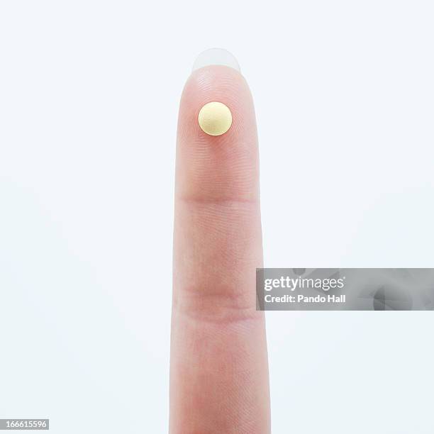 woman's finger with birth control pill - birth control pill bildbanksfoton och bilder