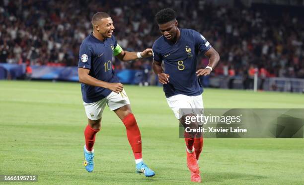 Aurelien Tchouameni of Team France celebrates his first goal with Kylian Mbappe during the UEFA EURO 2024 qualifying round group D match between...