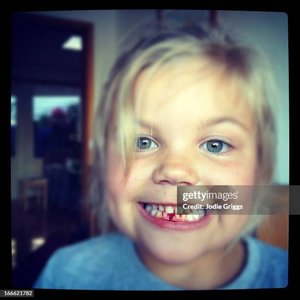 portrait of a child after just losing a baby tooth - portrait of a young girl with gappy teeth and blond hair stock pictures, royalty-free photos & images