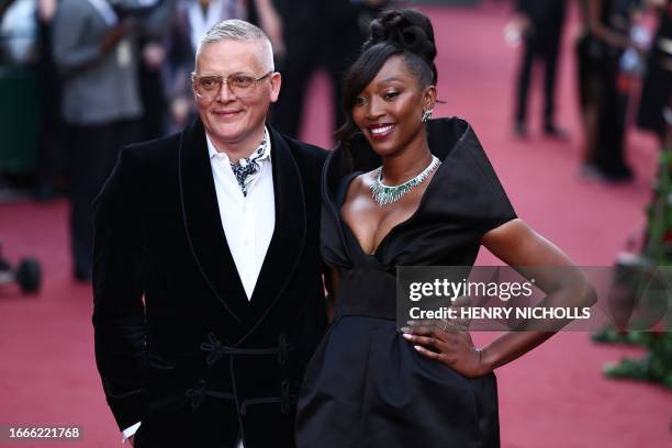 British designer Giles Deacon and British Vogue's publishing director Vanessa Kingori pose upon arrival to attend the "Vogue World: London" event at...