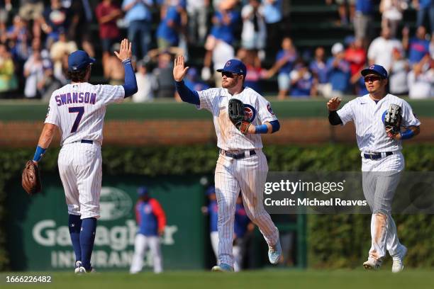 Dansby Swanson and Ian Happ of the Chicago Cubs celebrate after defeating the San Francisco Giants at Wrigley Field on September 06, 2023 in Chicago,...