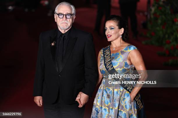 Scottish actor Brian Cox and his wife Nicole Ansari-Cox pose upon arrival to attend the "Vogue World: London" event at the Theatre Royal Drury Lane...