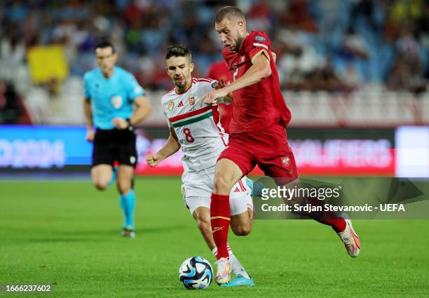 Adam Nagy of Hungary battles for possession with Strahinja Pavlovic of Serbia during the UEFA EURO 2024 European qualifier match between Serbia and...