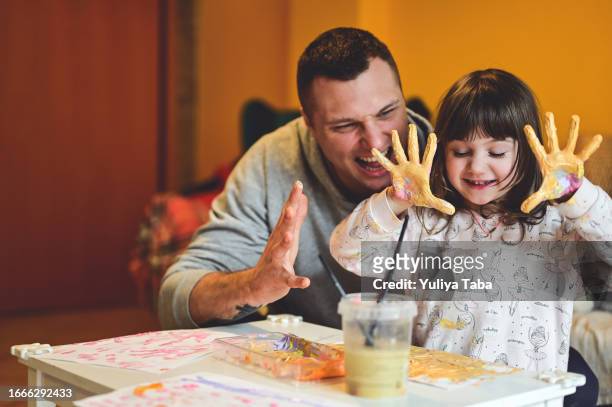 cheerful family with with painted hands having fun. - 4 girls finger painting stock pictures, royalty-free photos & images