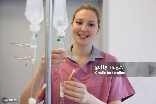 nurse is preparing an infusion - iv infusion stock pictures, royalty-free photos & images