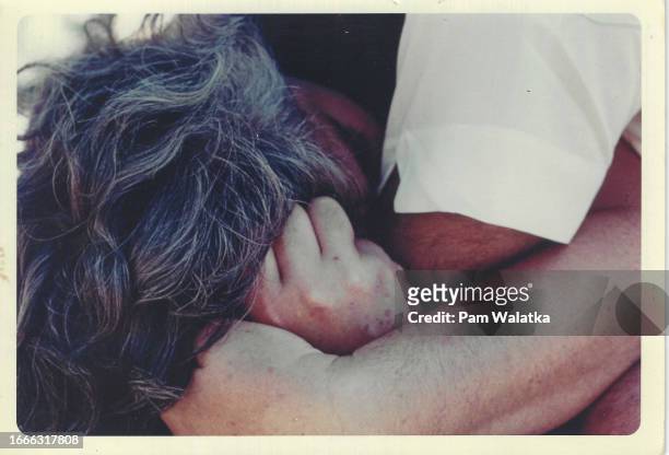 Close-up of American educator & Esalen Resident Fellow Betty Fuller as she is hugged during a Bioenergetics workshop at the Esalen Institute, Big...