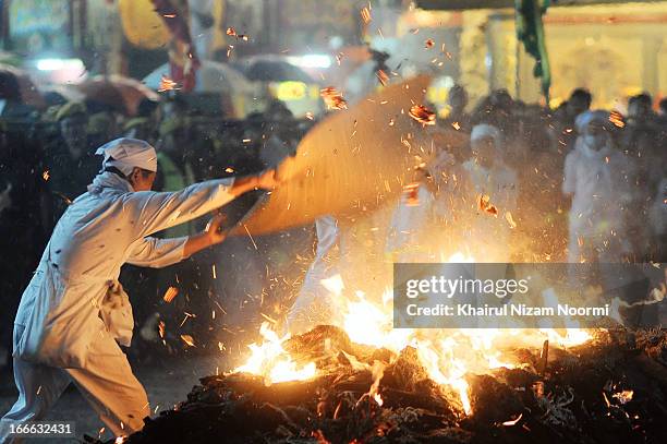 Devotee setting up the fire for The Nine Emperor Gods Festival is an annual Taoist celebration held from the first day to the ninth day of the lunar...