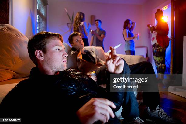 smoking pot at a house party - alcohol and smoking stockfoto's en -beelden