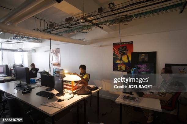 Employees work in a storyboard room on August 1, 2013 at the French animated movie studio Mac Guff, in Paris. Jacques Bled, French founder of French...