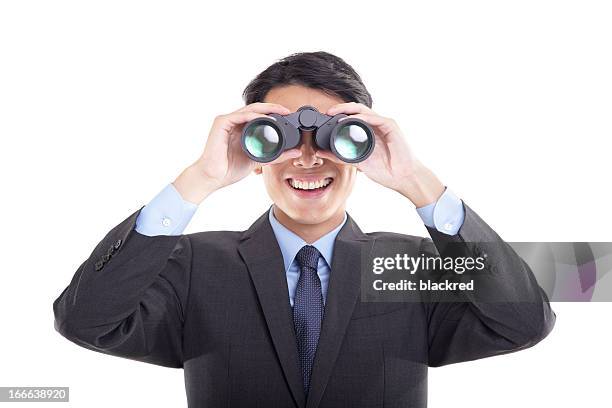 business man looking through binoculars - spy glass businessman stock pictures, royalty-free photos & images