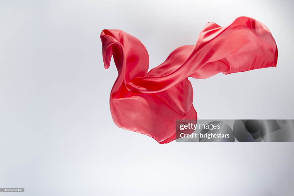 Floating red silk on a bright background