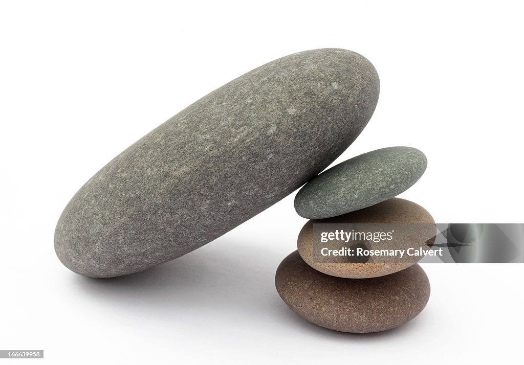 Three small pebbles supporting one large pebble