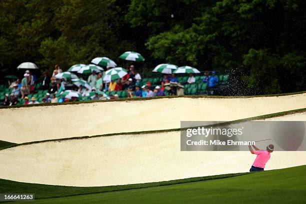 Brandt Snedeker of the United States hits out of the bunker on the fifth hole during the final round of the 2013 Masters Tournament at Augusta...