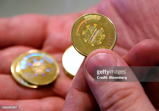 Mike Caldwell, of Casascius, displays Bitcoins that were just made for a photograph in Sandy, Utah, U.S., on Friday, April 12, 2013. Created four...