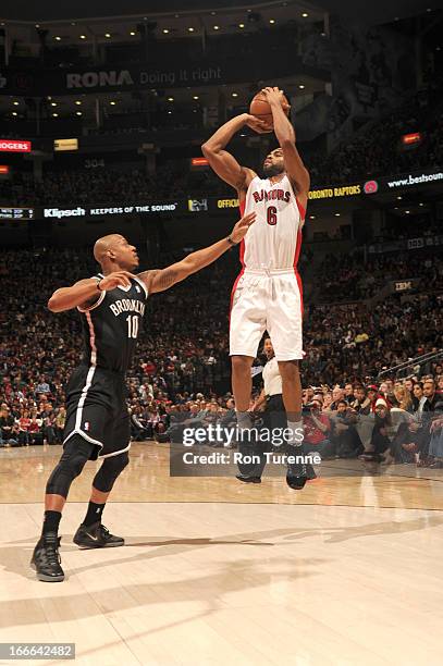 Alan Anderson of the Toronto Raptors goes for a jump shot Keith Bogans of the Brooklyn Nets during the game between the Toronto Raptors and the...