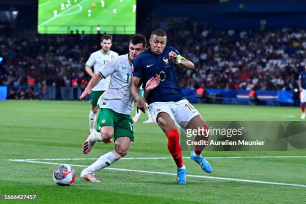 Kylian Mbappe of France and James McClean of Ireland fight for possession during the UEFA EURO 2024 European qualifier match between France and...