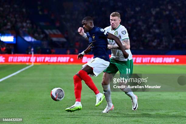 Ousmane Dembele of France and James McClean of Ireland fight for possession during the UEFA EURO 2024 European qualifier match between France and...