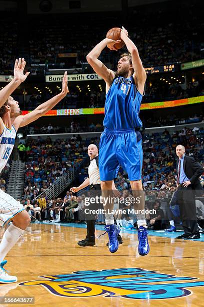Dirk Nowitzki of the Dallas Mavericks makes a shot, passing the 25,000 point career milestone, against Robin Lopez of the New Orleans Hornets during...