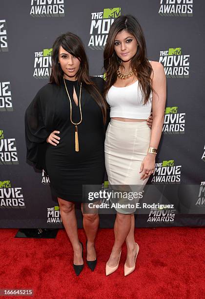 Personalities Kim Kardashian and Kylie Jenner arrive at the 2013 MTV Movie Awards at Sony Pictures Studios on April 14, 2013 in Culver City,...