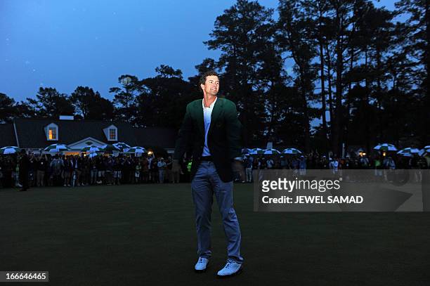 Adam Scott of Australia smiles while wearing his green jacket after winning the 2013 Masters Tournament at Augusta National Golf Club on April 14,...