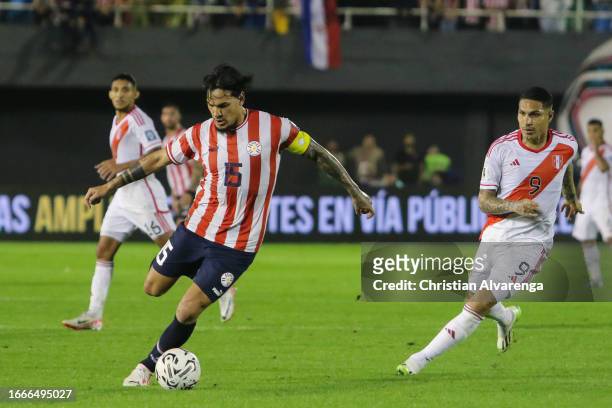 Gustavo Gomez of Paraguay controls the ball while followed by Paolo Guerrero of Peru during a FIFA World Cup 2026 Qualifier match between Paraguay...