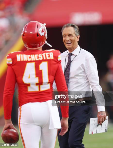 Broadcaster Cris Collinsworth talks to James Winchester of the Kansas City Chiefs prior to their game against the Detroit Lions at GEHA Field at...