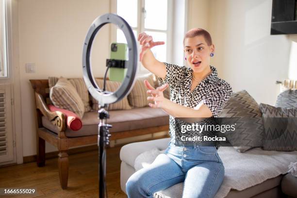 young woman is recording a vlog - ring light stock pictures, royalty-free photos & images