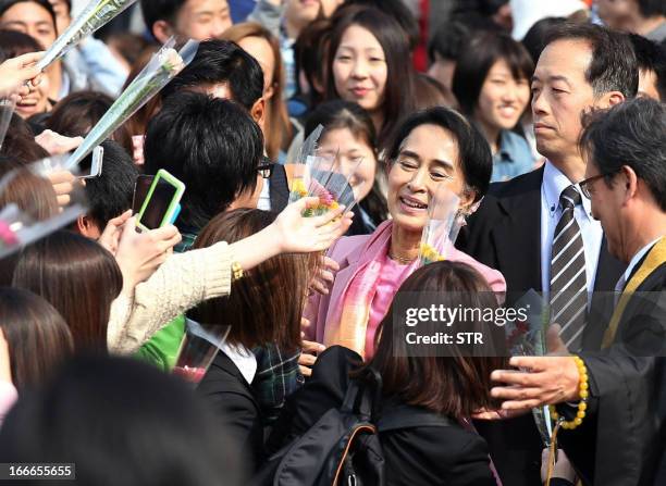 Myanmar's democracy leader Aung San Suu Kyi is greeted by students upon her arrival at the Ryukoku University in Kyoto, western Japan to deliver a...