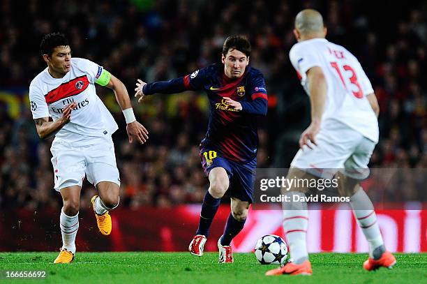 Lionel Messi of FC Barcelona duels for the ball with Thiago Silva of Paris Saint-Germain and Alex of Paris Saint-Germain during the UEFA Champions...