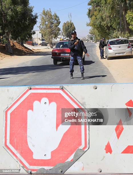 Hamas security men stop vehicles at a checkpoint on the outskirts of the border between Rafah town in the southern Gaza strip and Israel to prevent...