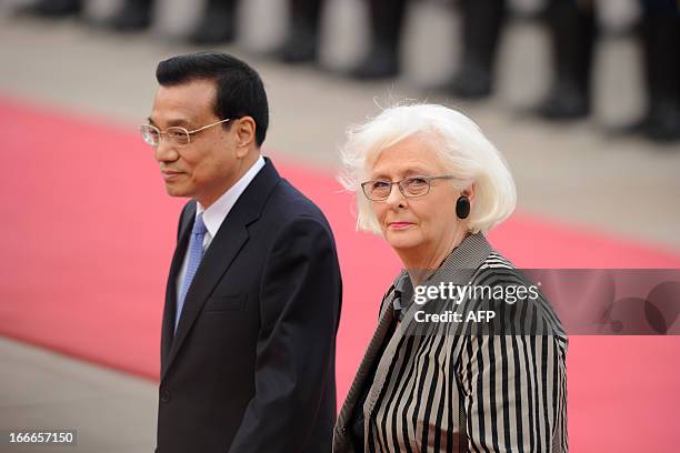 Chinese Premier Li Keqiang and Iceland Prime Minister Johanna Sigurdardottir inspect honour guards during a welcoming ceremony outside the Great Hall...