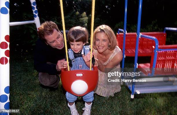 Actors John Travolta and Kelly Preston are photographed with son Jett for People Magazine in 1994 at home in Belair, California.