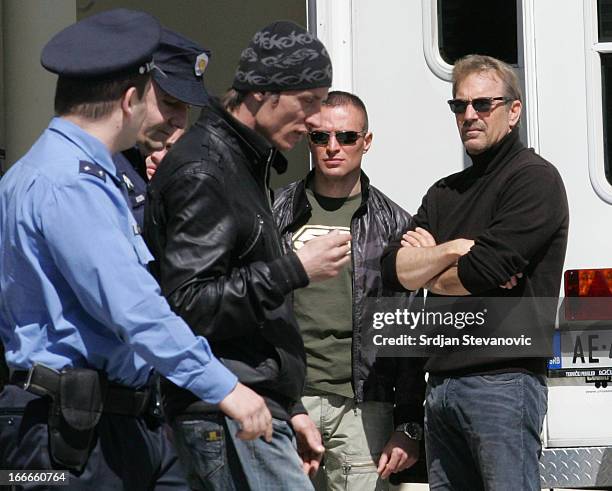 Kevin Costner watches as a man who is believed to be one of his fans is arrested by police on the set of his latest movie during the filming 'Three...