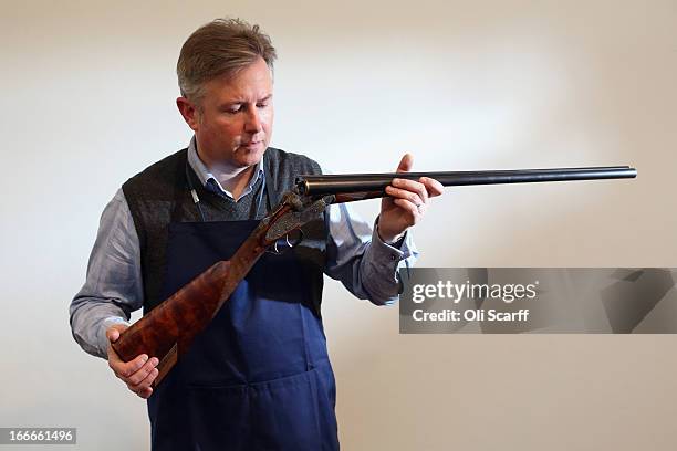 Antique firearms expert Gavin Gardiner poses with a 12-bore 'Russian Purdey' which is due to be auctioned on April 17, 2013 in the 'Fine Modern and...