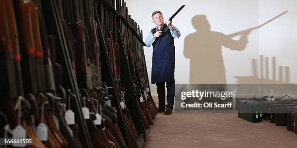 Antique firearms expert Gavin Gardiner poses with a 12-bore 'Russian Purdey' which is due to be auctioned on April 17, 2013 in the 'Fine Modern and...