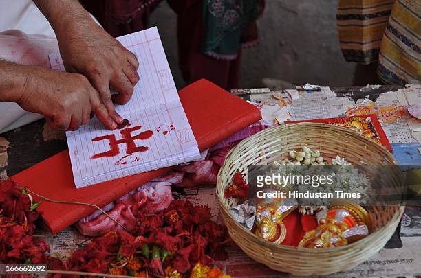 Priest performing rituals to ledger book at Kali Temple during Bengali new year celebration on April 15, 2013 in Kolkata, India. West Bengal...